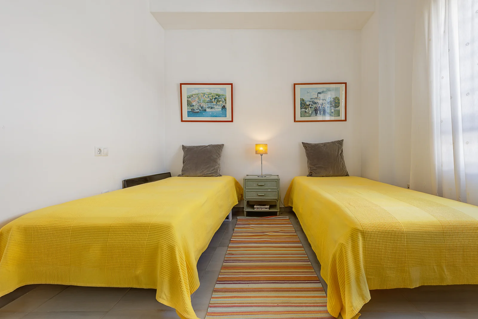 Bedroom with twin beds and white wardrobes in a Nuevo Portil villa