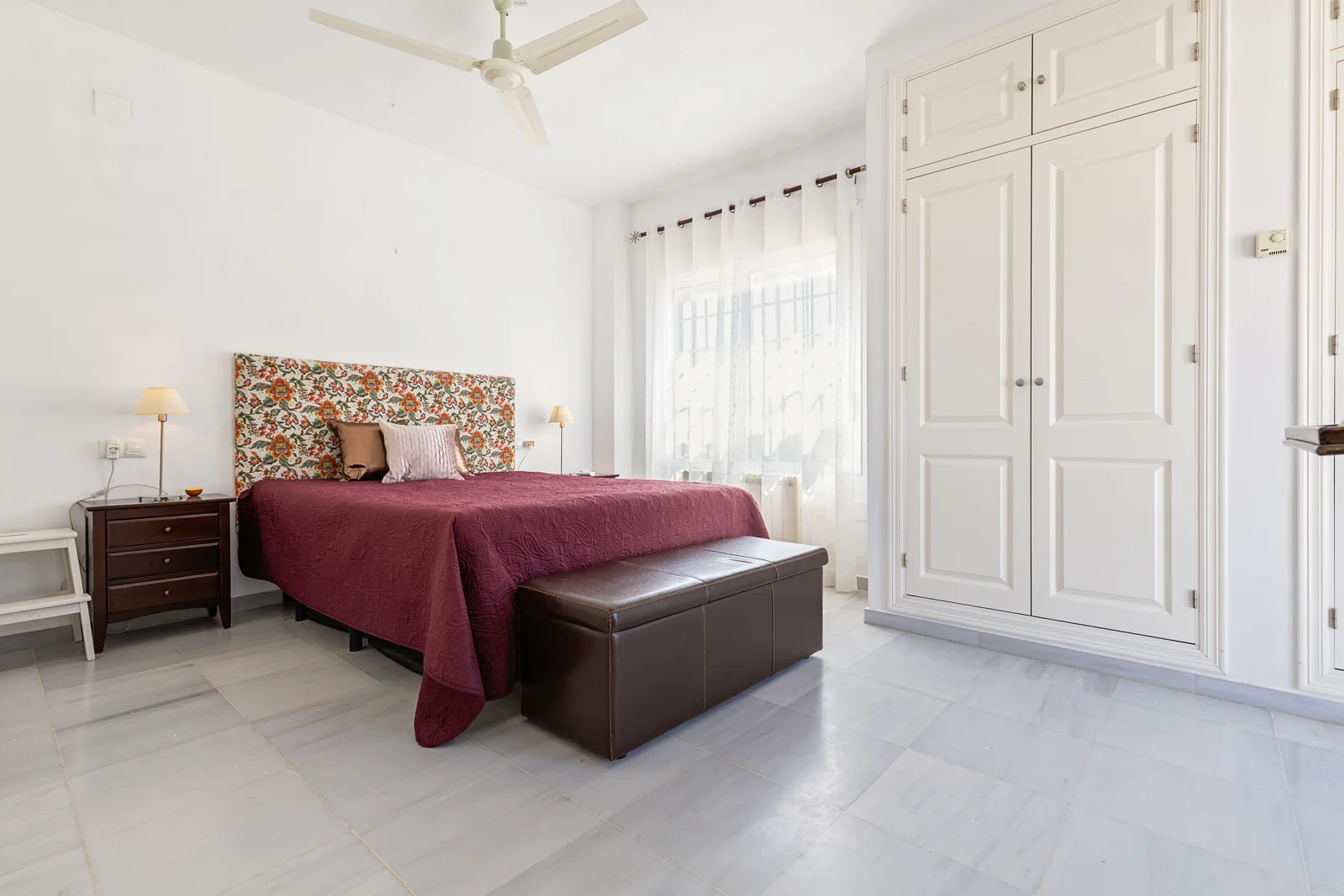 Bright main bedroom with a double bed and wardrobes in a Nuevo Portil villa
