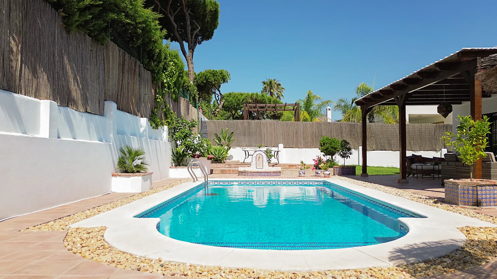 Private pool and veranda of a villa in Nuevo Portil, Huelva