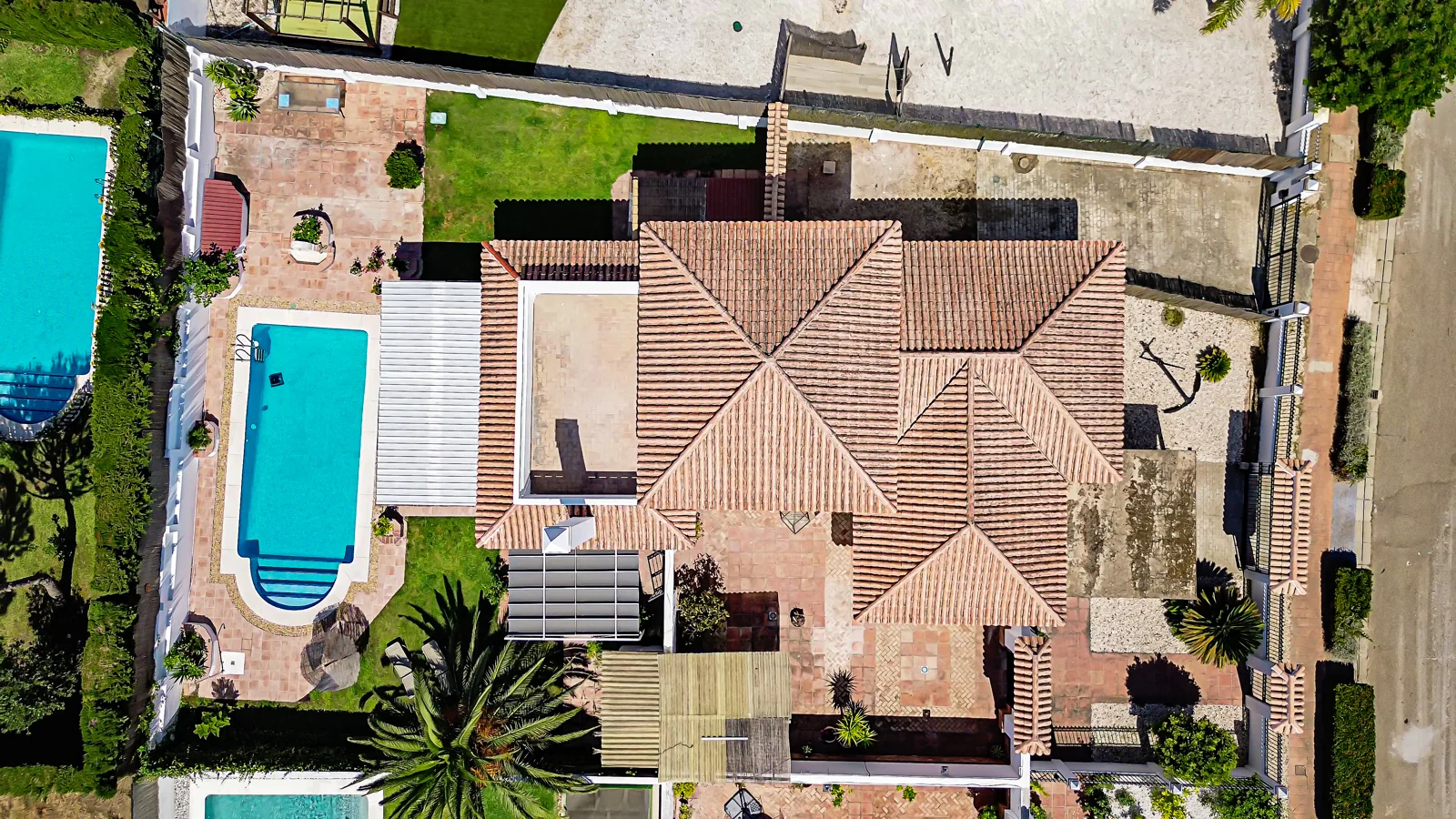 Aerial drone view of a villa with a pool and garden in Nuevo Portil, Huelva